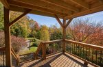 The covered downstairs deck provides access to the yard below, hiking, and firepit.